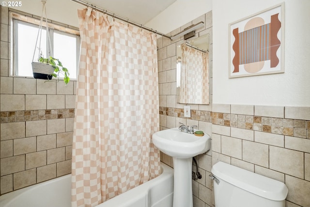 full bathroom featuring toilet, tile walls, and shower / bathtub combination with curtain