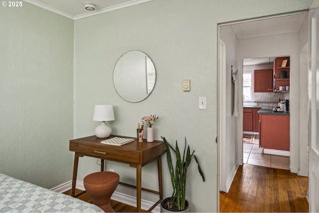 interior space featuring baseboards, dark wood-style flooring, and crown molding