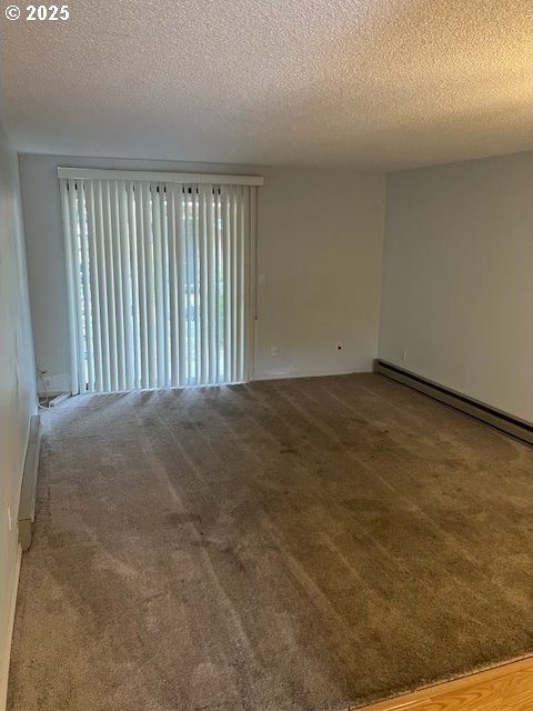 3404 19th Ave Unit 103, Forest Grove, OR 97116 - carpeted empty room with a textured ceiling and baseboard heating
