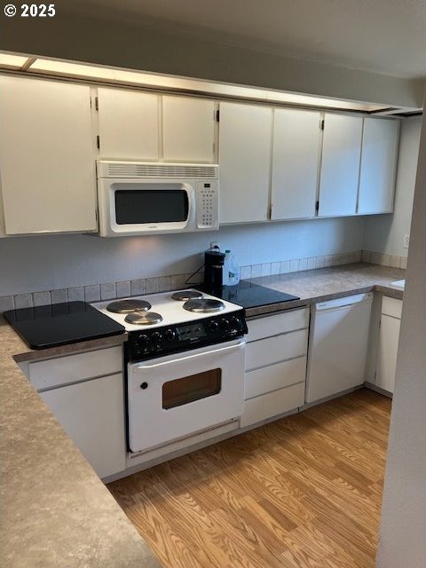 3404 19th Ave Unit 103, Forest Grove, OR 97116 - kitchen with white appliances, white cabinets, and light wood-style flooring