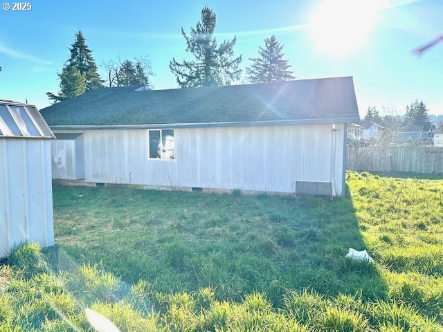 exterior space with a yard and a storage unit