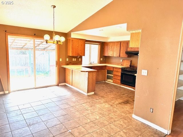 kitchen with kitchen peninsula, black range oven, vaulted ceiling, sink, and an inviting chandelier