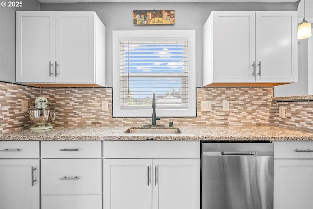 6955 N Concord Ave, Portland, OR 97217 - kitchen featuring stainless steel dishwasher, a sink, white cabinets, decorative backsplash, and light stone counters