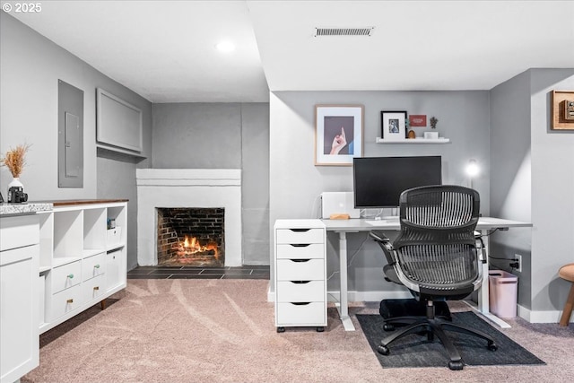 6955 N Concord Ave, Portland, OR 97217 - office area with carpet floors, a fireplace with flush hearth, baseboards, and electric panel
