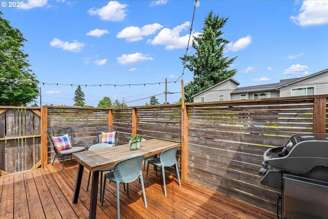 6955 N Concord Ave, Portland, OR 97217 - wooden deck featuring outdoor dining space and a fenced backyard