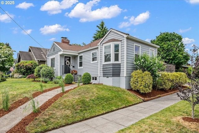 6955 N Concord Ave, Portland, OR 97217 - view of front of property featuring a front lawn and a chimney