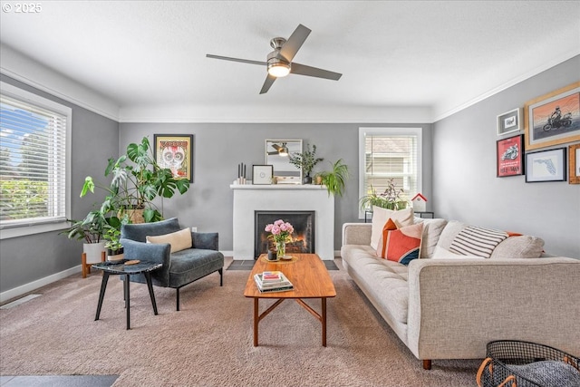 6955 N Concord Ave, Portland, OR 97217 - living room featuring healthy amount of natural light, ceiling fan, a fireplace with flush hearth, light carpet, and ornamental molding