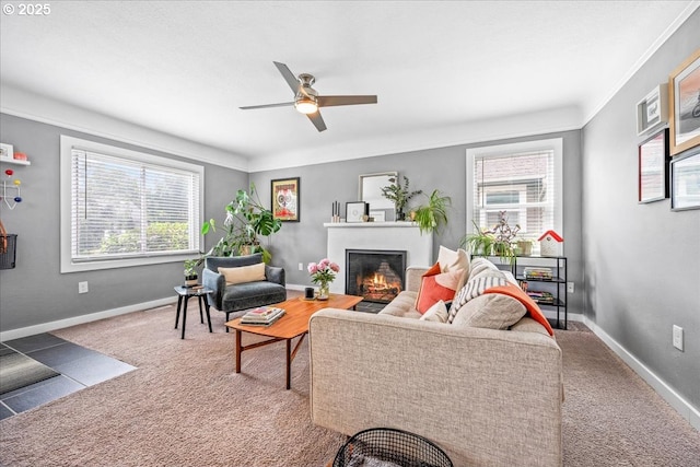 6955 N Concord Ave, Portland, OR 97217 - living area featuring healthy amount of natural light, a ceiling fan, a lit fireplace, carpet, and crown molding