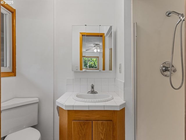 3123 SE 129th Ave, Portland, OR 97236 - full bathroom with a shower, vanity, ceiling fan, and tasteful backsplash