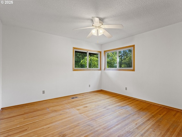 3123 SE 129th Ave, Portland, OR 97236 - unfurnished room with hardwood / wood-style floors, a ceiling fan, and a textured ceiling