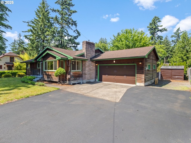 3123 SE 129th Ave, Portland, OR 97236 - view of front of home featuring driveway, a chimney, a front yard, a storage unit, and a garage