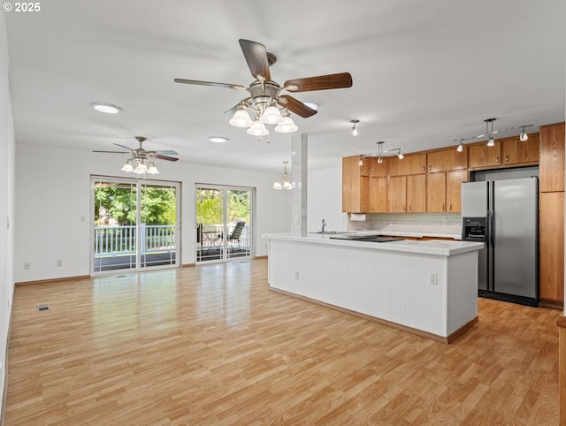 3123 SE 129th Ave, Portland, OR 97236 - kitchen featuring stainless steel fridge with ice dispenser, open floor plan, ceiling fan, light wood-type flooring, and a peninsula