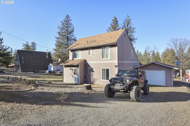 view of front of property featuring a garage and an outdoor structure