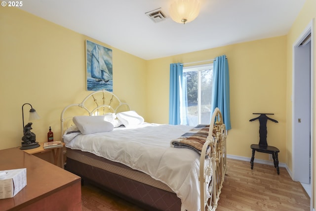 bedroom with hardwood / wood-style flooring