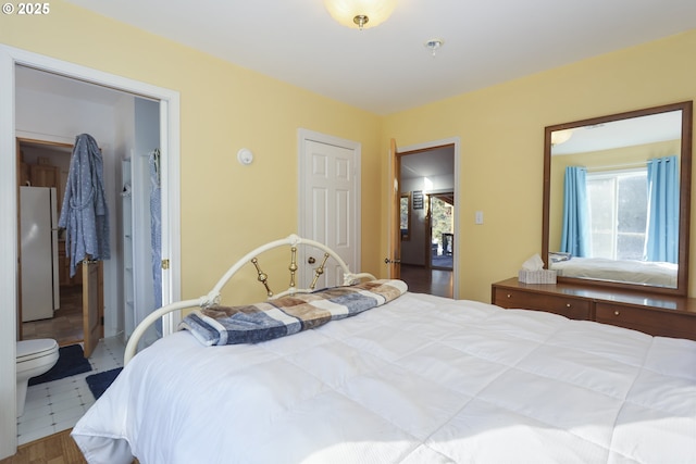 bedroom featuring white fridge and a closet