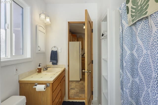 bathroom featuring vanity and toilet