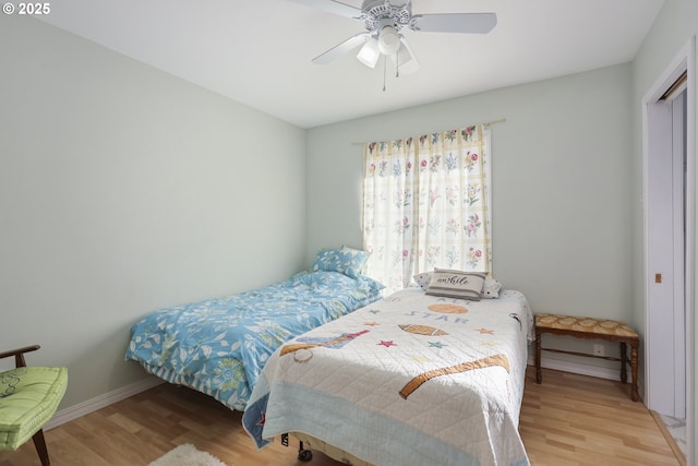 bedroom with wood-type flooring and ceiling fan