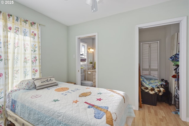 bedroom featuring ensuite bath and light hardwood / wood-style flooring