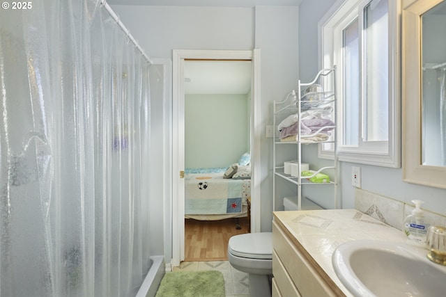 bathroom with vanity, tile patterned flooring, curtained shower, and toilet