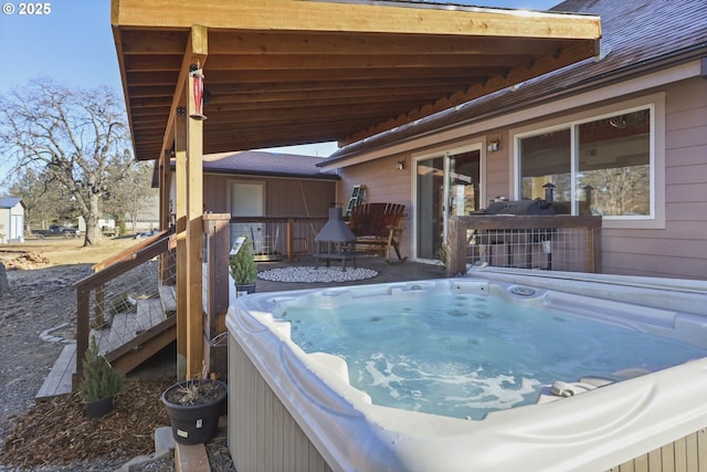 wooden terrace featuring a hot tub