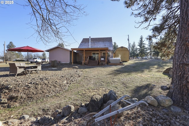 rear view of property with a shed