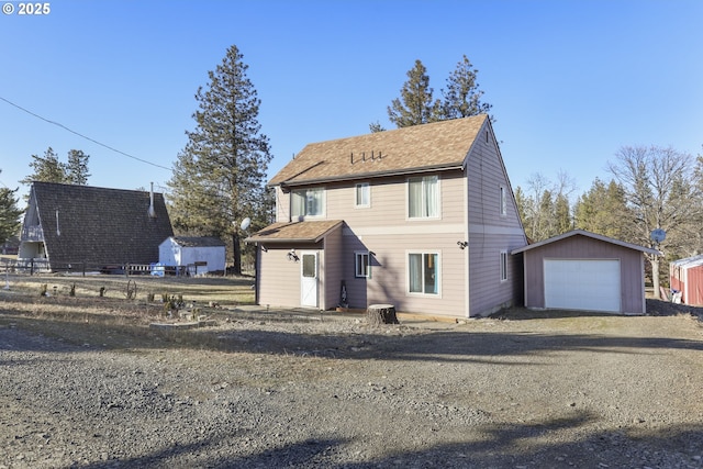 view of front of house with a garage and an outdoor structure