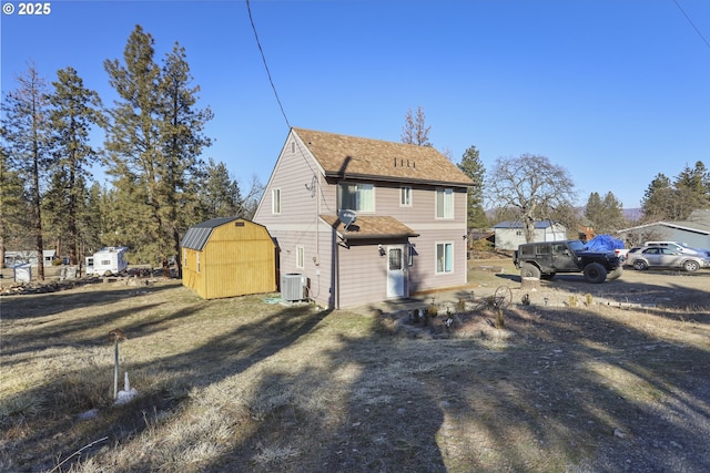 back of house with cooling unit and a storage unit