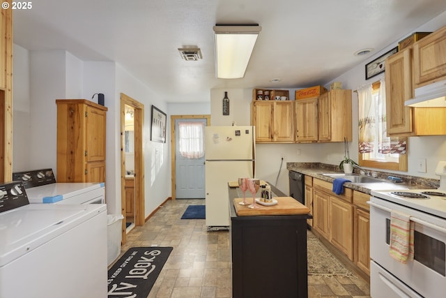 kitchen with a kitchen island, washer and dryer, and white appliances