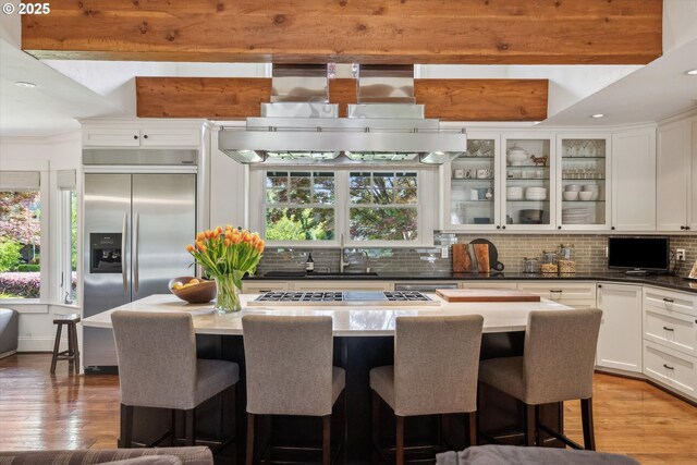 2550 Dellwood Dr, Lake Oswego, OR 97034 - kitchen with built in fridge, a sink, backsplash, range hood, and white cabinets