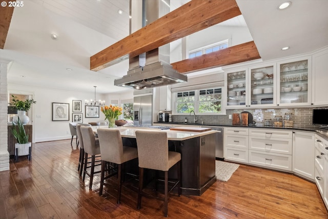 2550 Dellwood Dr, Lake Oswego, OR 97034 - kitchen with recessed lighting, decorative backsplash, a kitchen island, appliances with stainless steel finishes, and white cabinetry