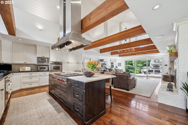 2550 Dellwood Dr, Lake Oswego, OR 97034 - kitchen featuring stainless steel appliances, island range hood, white cabinets, a kitchen bar, and open floor plan