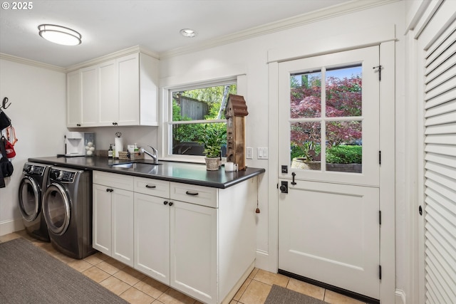 2550 Dellwood Dr, Lake Oswego, OR 97034 - laundry area featuring washing machine and clothes dryer, cabinet space, light tile patterned floors, crown molding, and baseboards