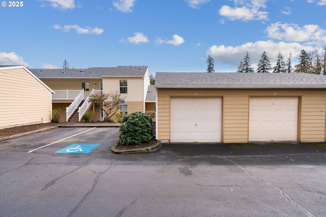 13216 NE Salmon Creek Ave Unit E8, Vancouver, WA 98686 - view of front facade featuring community garages, stairway, and an outdoor structure
