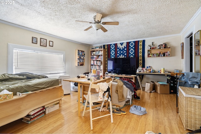 bedroom with crown molding, a textured ceiling, wood finished floors, and ceiling fan