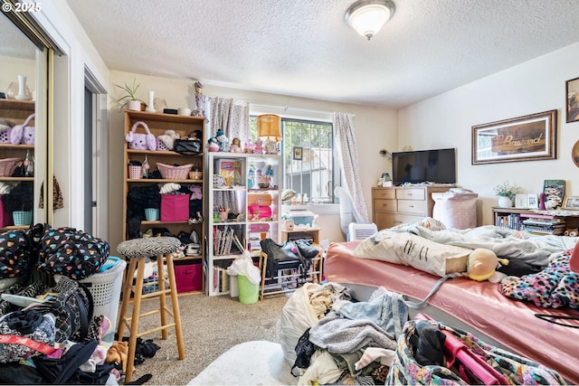 bedroom featuring carpet floors and a textured ceiling