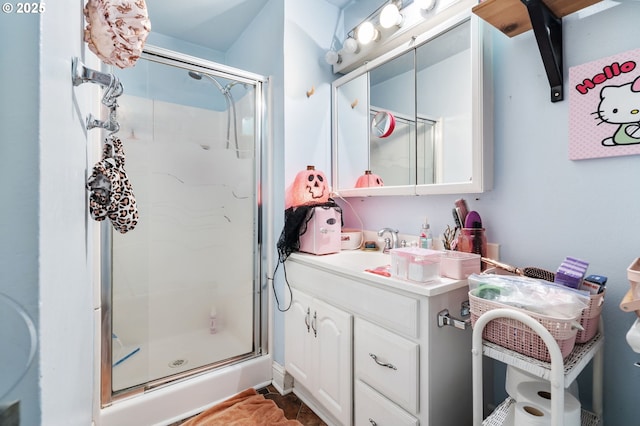 bathroom featuring a shower stall and vanity