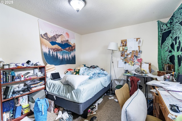 bedroom featuring carpet and a textured ceiling