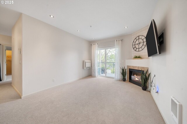 10664 NE Holly St # 206, Hillsboro, OR 97006 - unfurnished living room with carpet floors, a glass covered fireplace, recessed lighting, and heating unit