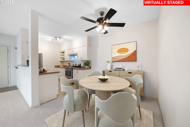 10664 NE Holly St # 206, Hillsboro, OR 97006 - dining room featuring a ceiling fan and light carpet
