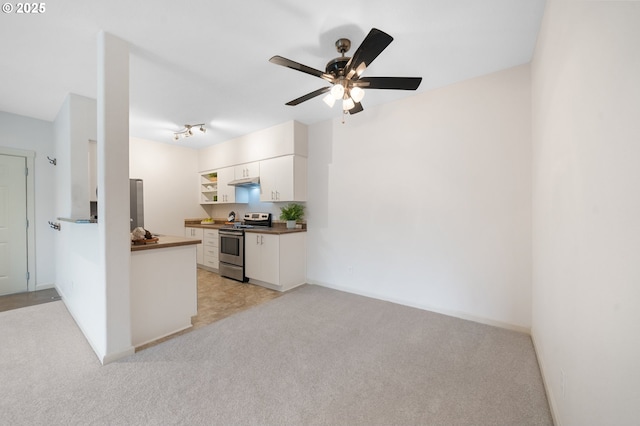 10664 NE Holly St # 206, Hillsboro, OR 97006 - kitchen featuring stainless steel range, white cabinetry, dark countertops, light colored carpet, and ceiling fan