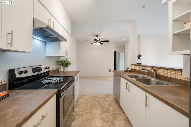 10664 NE Holly St # 206, Hillsboro, OR 97006 - kitchen featuring stainless steel appliances, under cabinet range hood, dark countertops, and recessed lighting