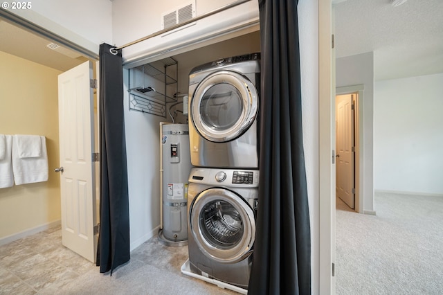 10664 NE Holly St # 206, Hillsboro, OR 97006 - washroom with stacked washing machine and dryer, secured water heater, and carpet