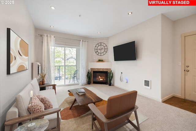 10664 NE Holly St # 206, Hillsboro, OR 97006 - carpeted living room featuring recessed lighting and a glass covered fireplace