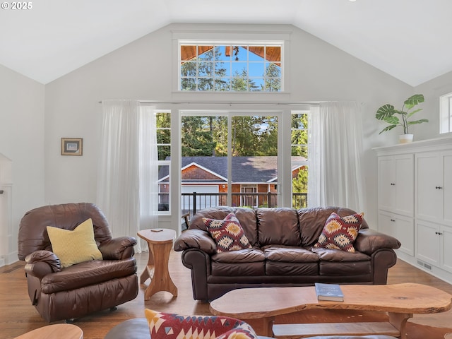 10305 Pine Ridge Dr, Manzanita, OR 97130 - living room featuring high vaulted ceiling and wood finished floors