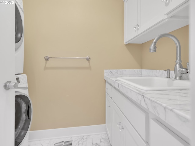 10305 Pine Ridge Dr, Manzanita, OR 97130 - washroom with cabinet space, estacked washer and dryer, and light marble finish floors