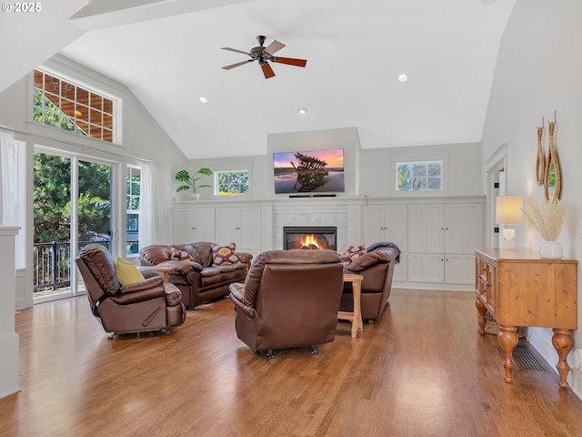 10305 Pine Ridge Dr, Manzanita, OR 97130 - living area with high vaulted ceiling, light wood-type flooring, a premium fireplace, ceiling fan, and recessed lighting