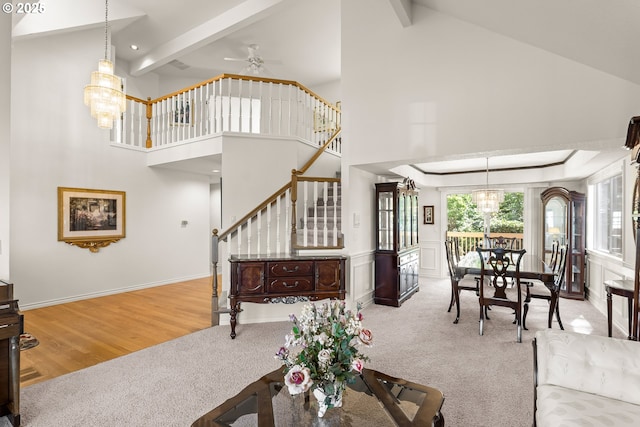15150 SE Lostine Dr, Clackamas, OR 97015 - living area featuring carpet floors, stairway, a chandelier, beam ceiling, and high vaulted ceiling