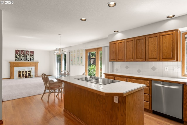 15150 SE Lostine Dr, Clackamas, OR 97015 - kitchen with dishwasher, tile counters, electric stovetop, brown cabinetry, and tasteful backsplash