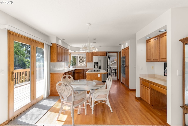 15150 SE Lostine Dr, Clackamas, OR 97015 - dining area featuring light wood-style floors, a chandelier, plenty of natural light, and recessed lighting