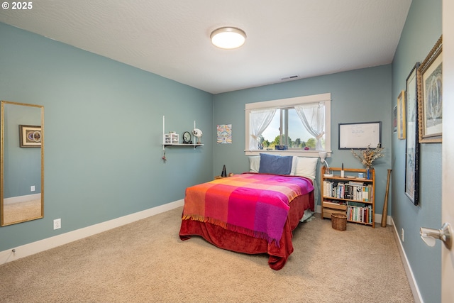 carpeted bedroom with baseboards and visible vents